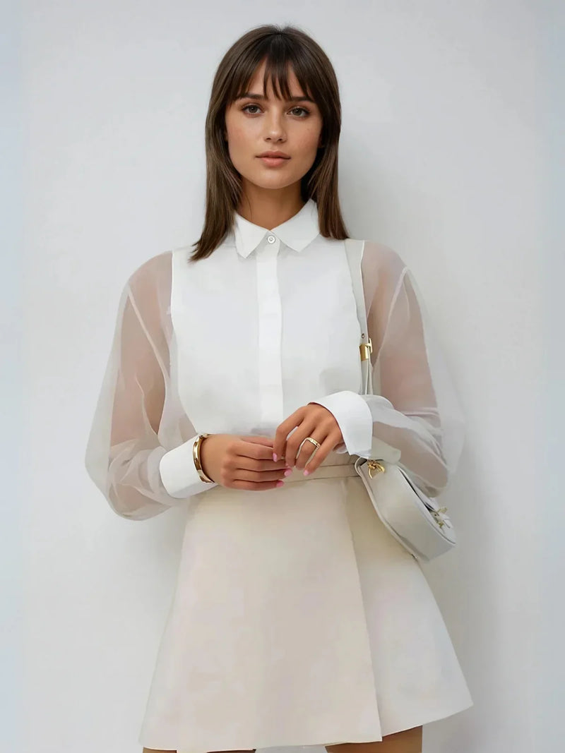 Top trasparente in organza con maniche a sbuffo e revers